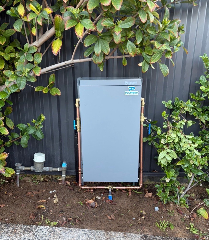 BWT filtration system installed among garden shrubs